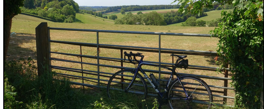Bike leaning against a field gate with stunning Chilterns Valley backdrop