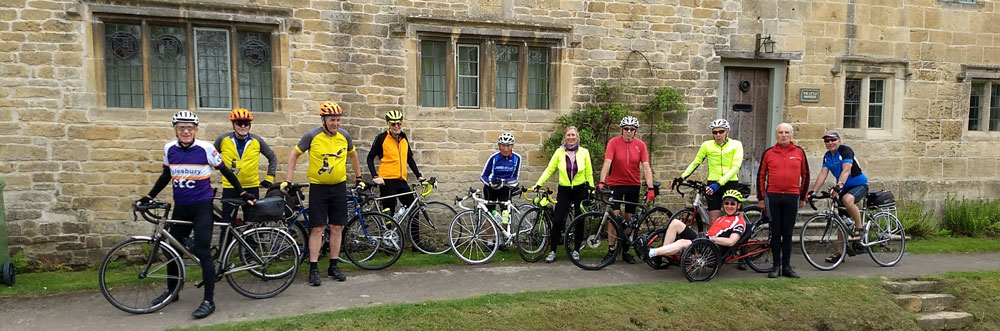 Midweek group standing outside an old building with mullioned windows